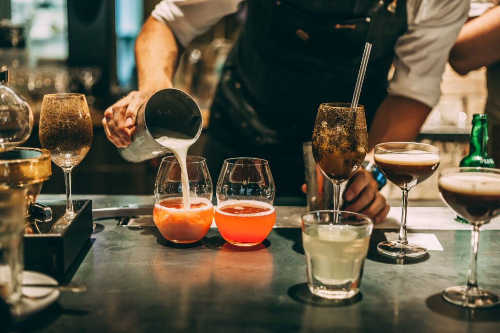 The bartender making an alcoholic cocktail, a summer cocktail in the bar